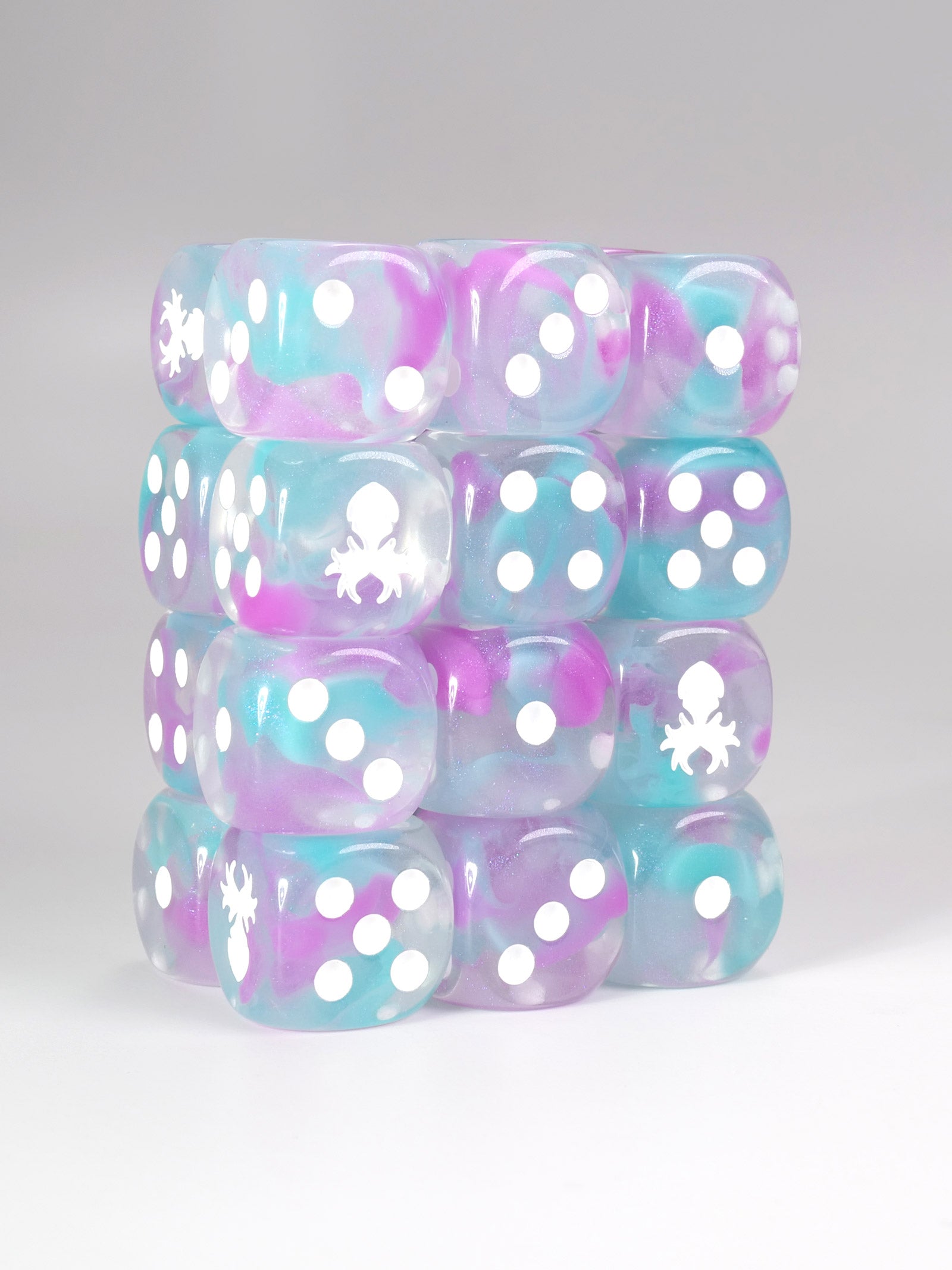 Stack of d6 pip dice with pastel colors and white patterns on a gray background